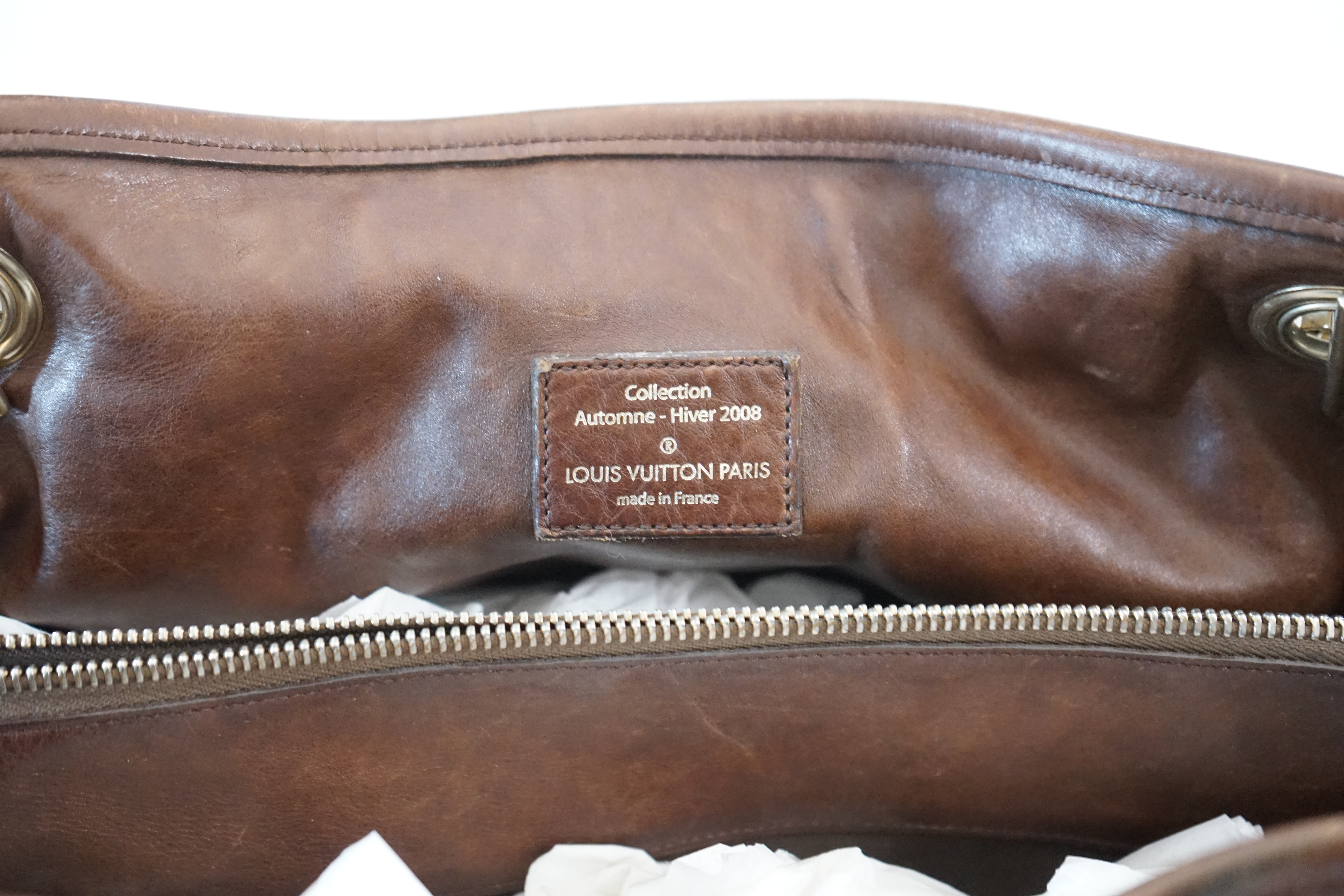 A Louis Vuitton Whisper brown leather handbag, width 31cm, depth 22cm, approx height 26cm